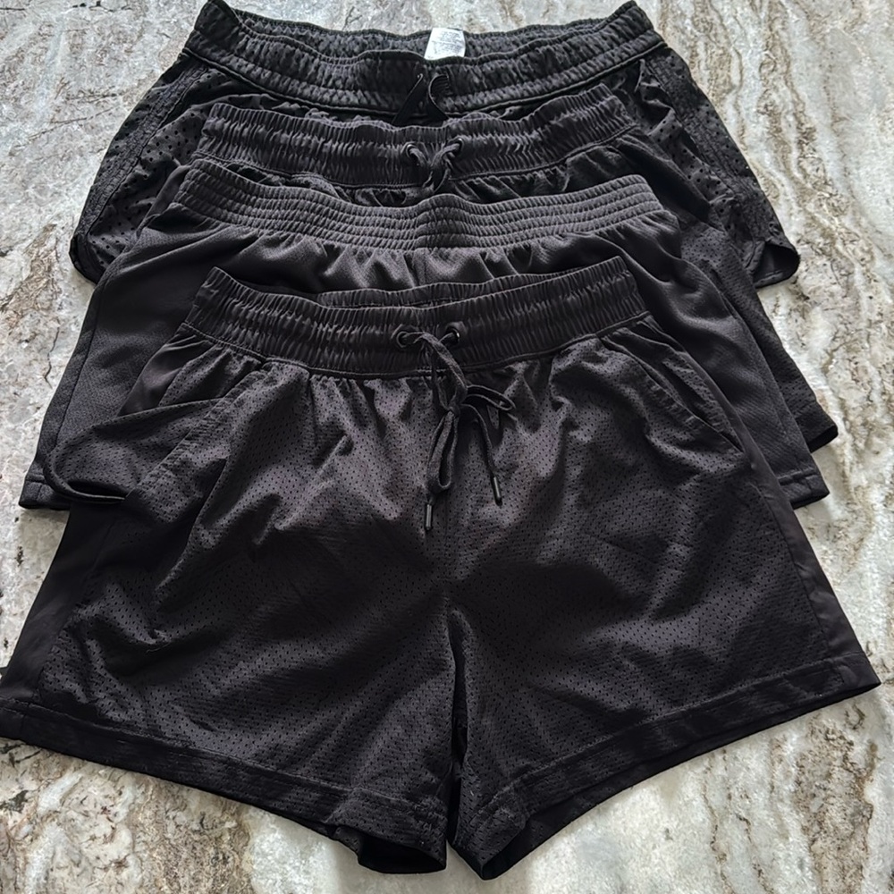 Group of 4 women’s black athletic shorts.